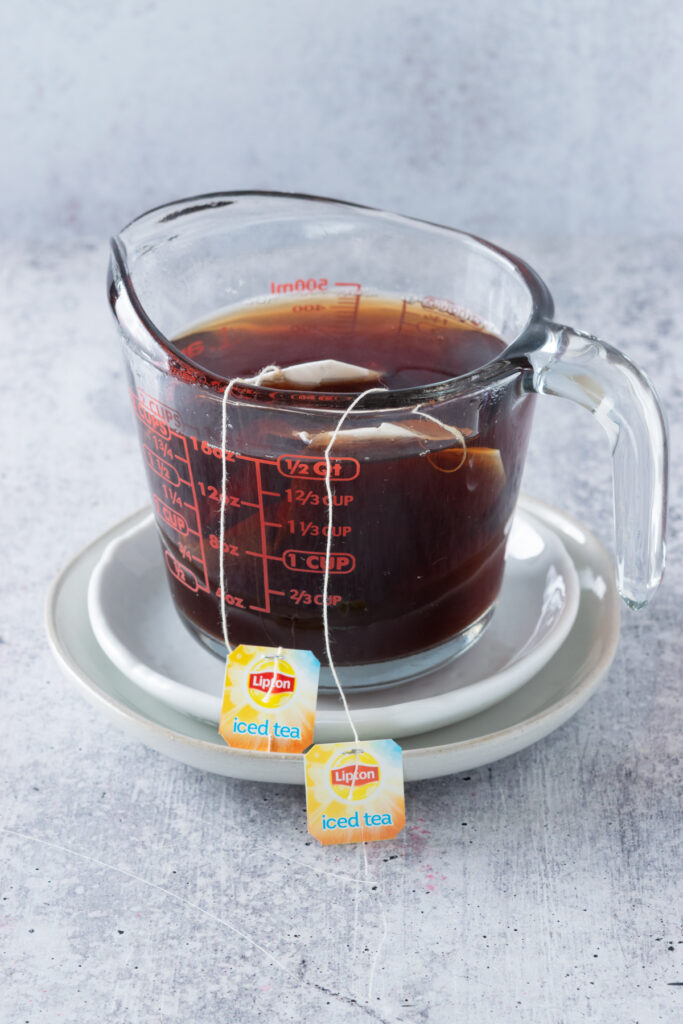 Brewing two Lipton tea bags in a large glass Pyrex measuring cup.