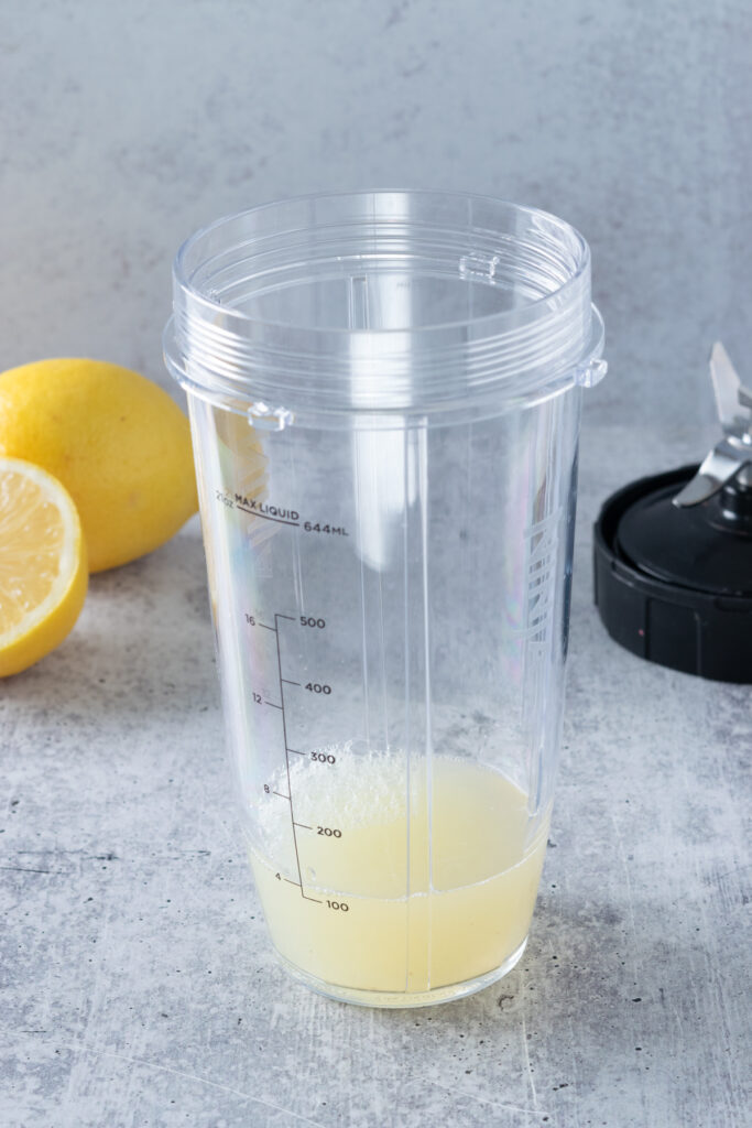 Fresh lemon juice added to blender cup.