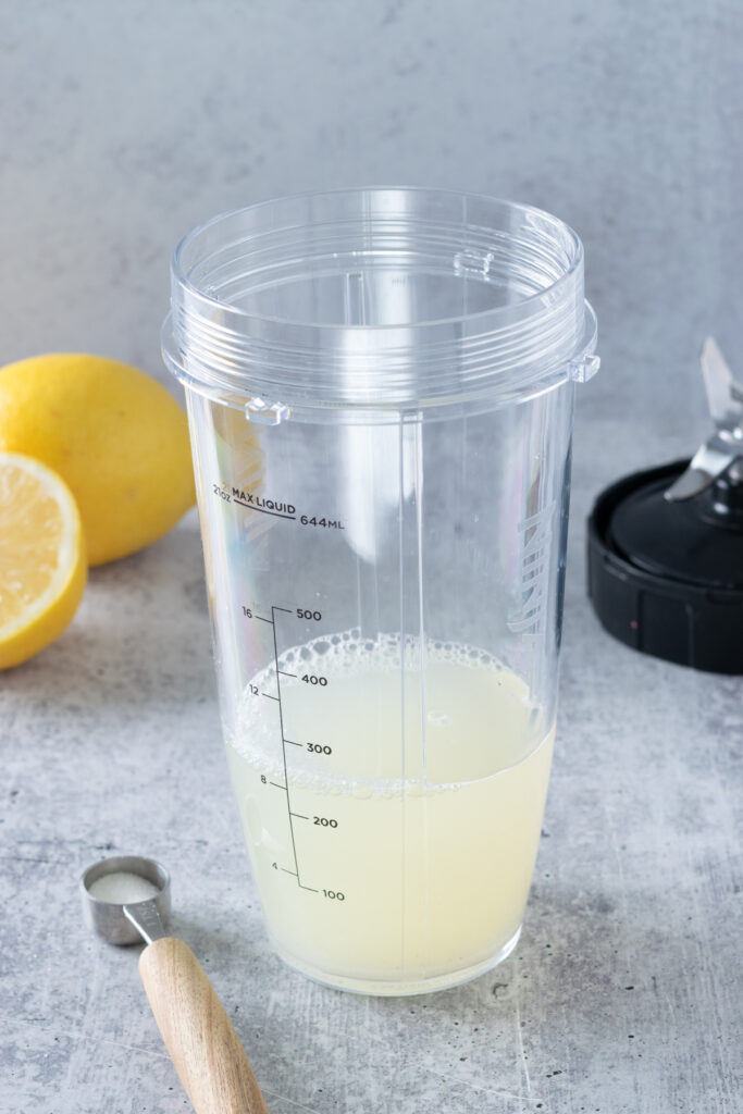Sugar and water and to the lemon juice in the blender cup.