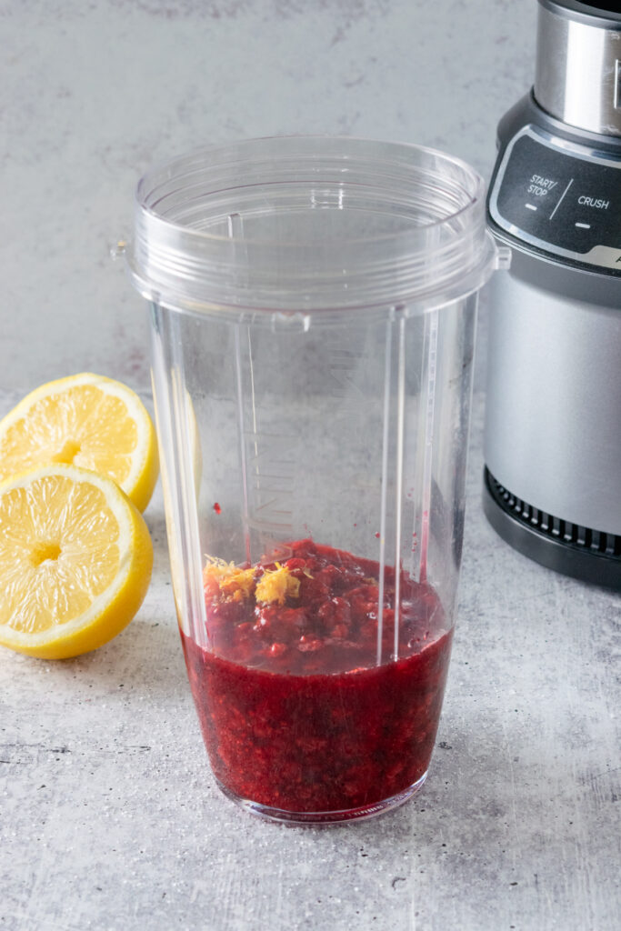Fresh lemon juice and lemon zest added to blender container with the raspberries.