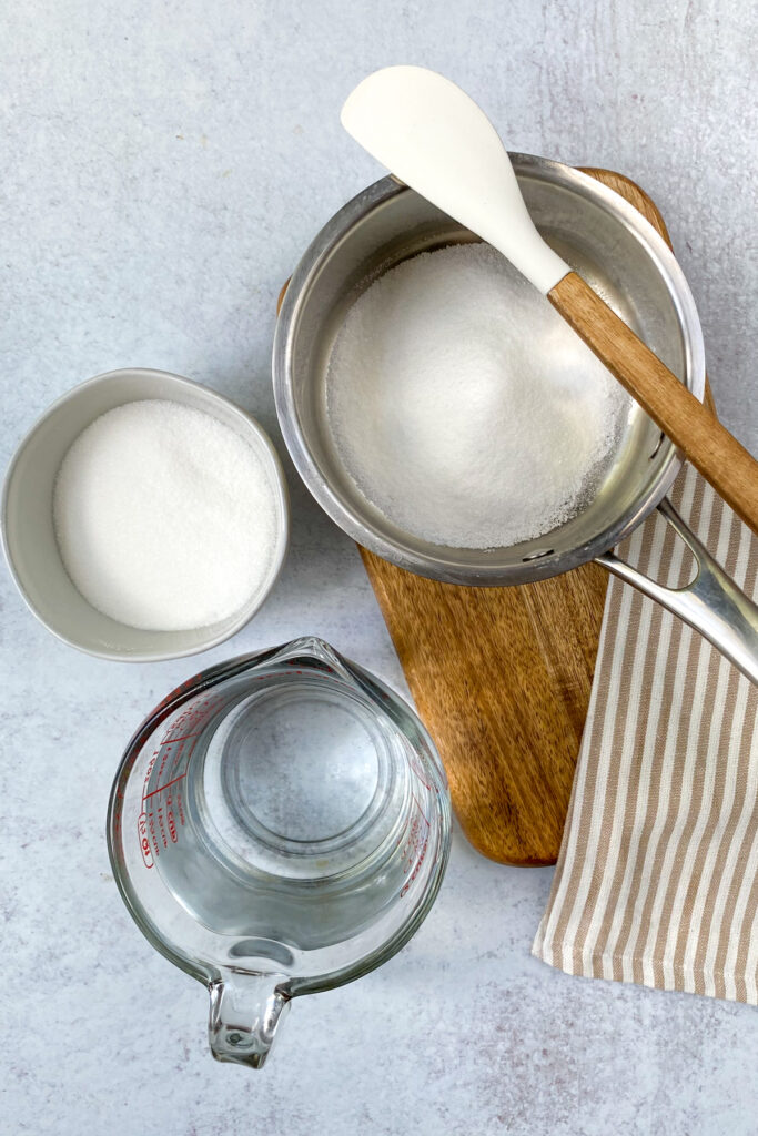 Making simple syrup in a small saucepan with sugar and water.