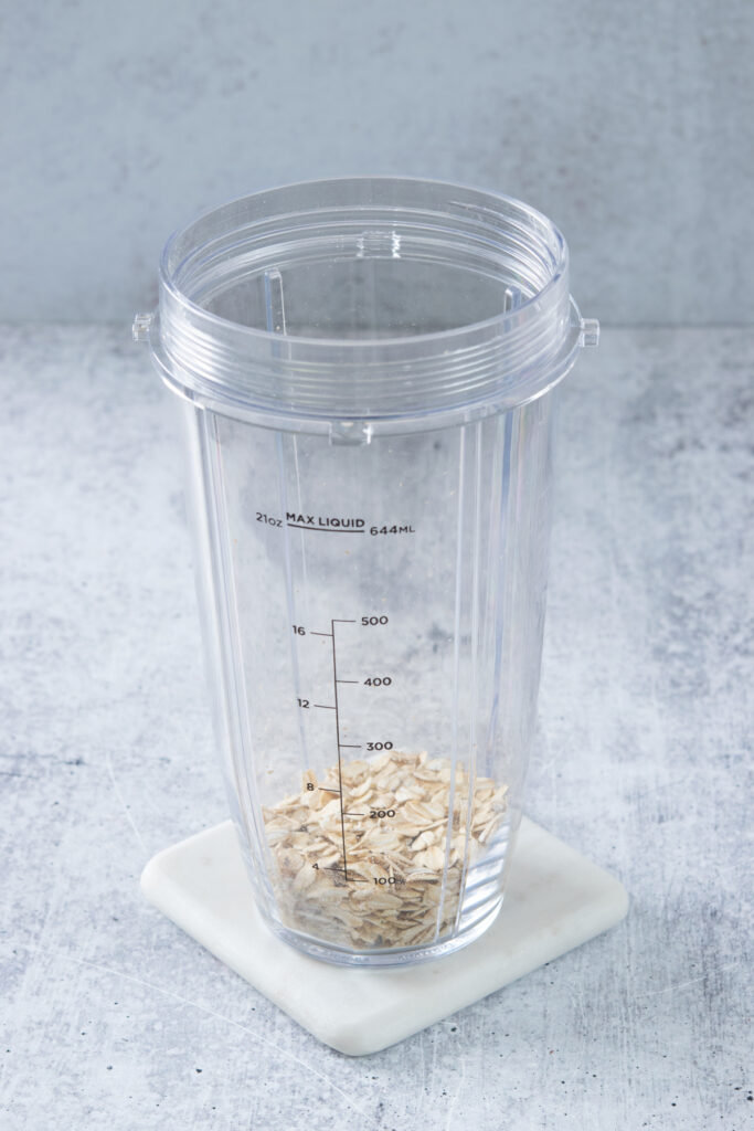 The first step to making an oatmeal smoothie is add oats to blender cup.