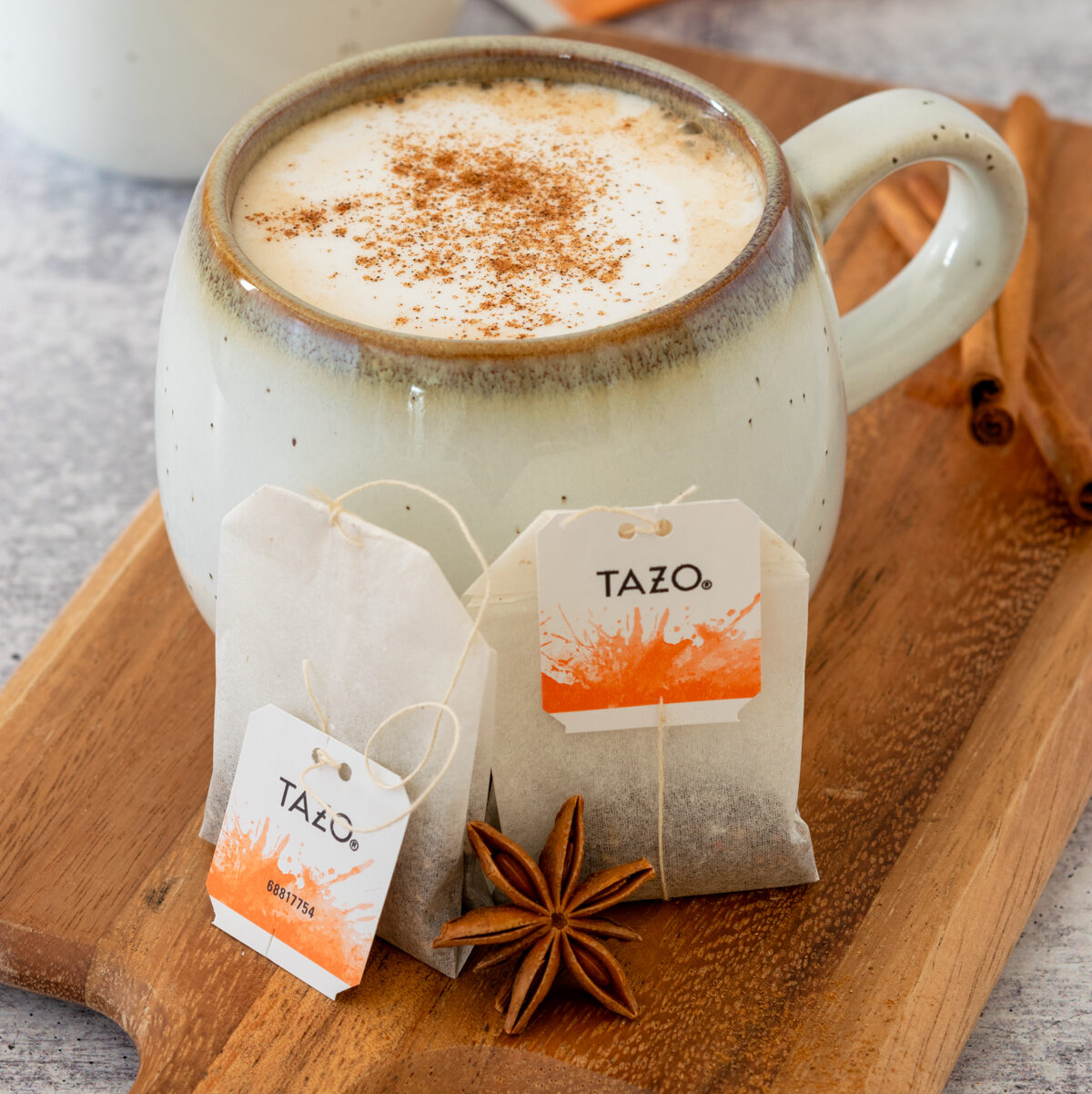 Navigation image for hot tea drink recipes, showing a mug of creamy brewed tea with tea bags.