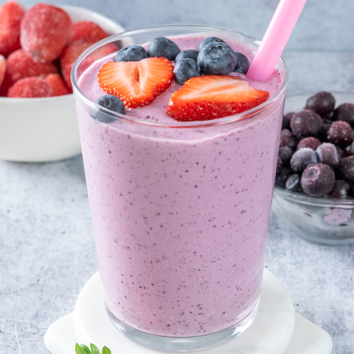 Navigation image for smoothie recipes, showing a purple strawberry blueberry smoothie in a glass garnished with fresh fruit.