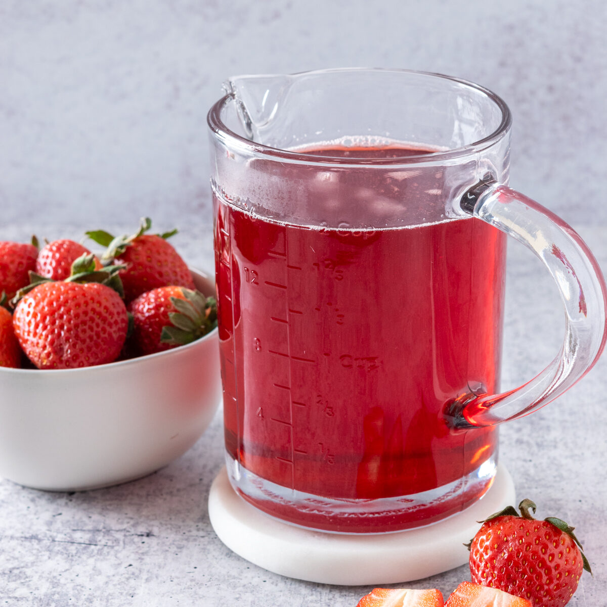 Navigation image for simple syrup and puree recipes, showing a jar of homemade strawberry syrup.